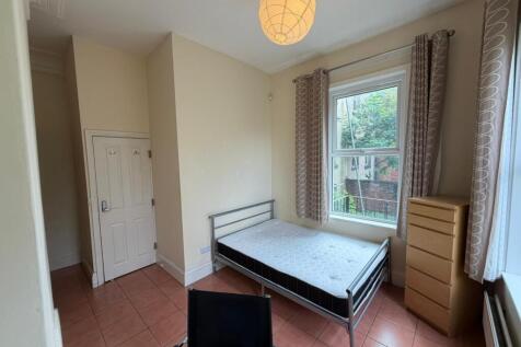 Bright bedroom with double bed and large window...