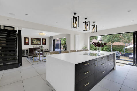 Open plan kitchen dining with bi-folds to garden