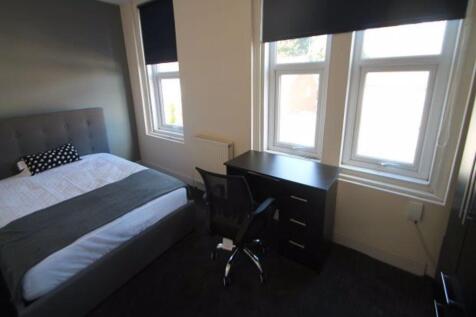 A cozy bedroom featuring a double bed with a he...