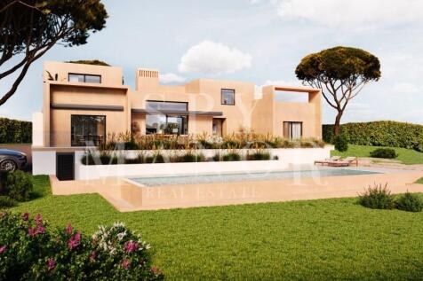Modern contemporary villa exterior with private swimming pool and landscaped gardens in Salicos Carvoeiro Algarve.