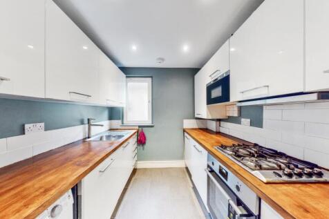 Fitted separate white lacquered style kitchen with