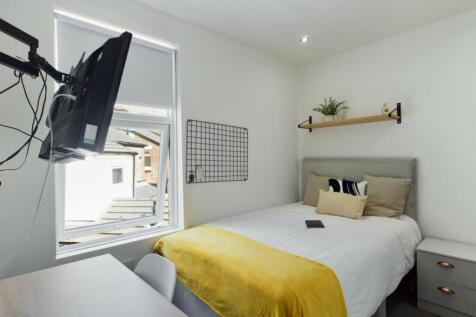 A bright and inviting double bedroom with moder...