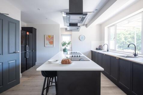 Modern kitchen with a breakfast island and sink...