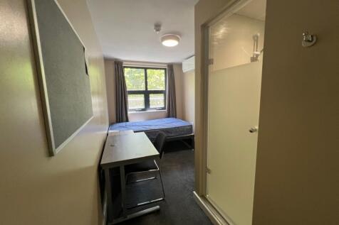 Neat single bedroom with a study desk and chair...