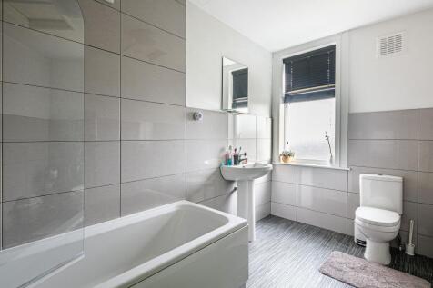 Bright, modern bathroom with a full bath, pedes...