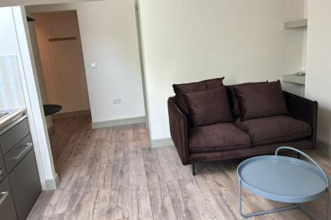 Sleek modern lounge with comfy sofa and wood fl...