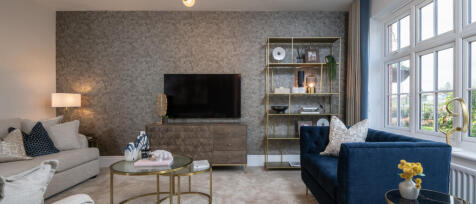 Nice looking living room with 2 sofa sitting in front of each other, a TV wall and 2 golden coffee t