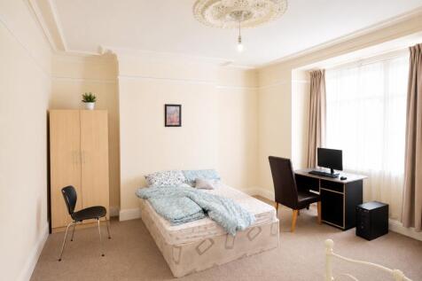 Grand bright bedroom with study desk and ornate...