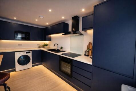 Modern navy kitchen with integrated appliances...