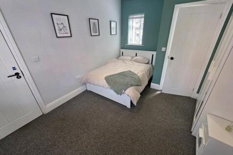 Bright and cozy double bedroom featuring a comf...