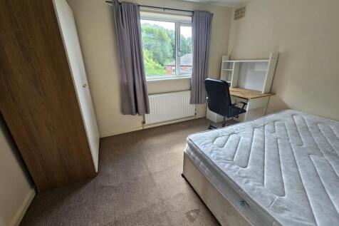 A bright, well-maintained bedroom featuring a c...