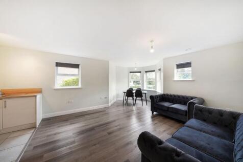 Bright, open-plan lounge with plush seating...