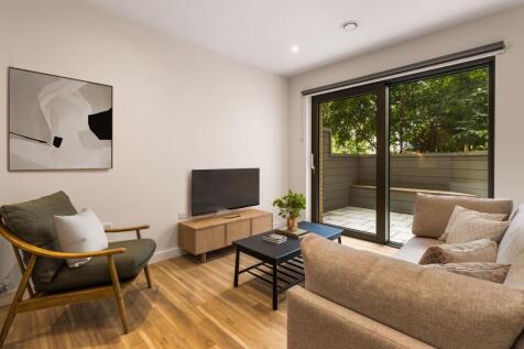 Relax in this cozy living space, featuring seamless indoor-outdoor connectivity.