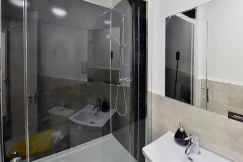 Modern bathroom suite with a sleek glass shower...