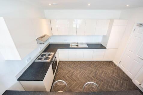 Modern kitchen with sleek white cabinetry...