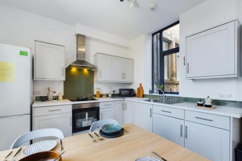 A bright and modern kitchen with ample space an...