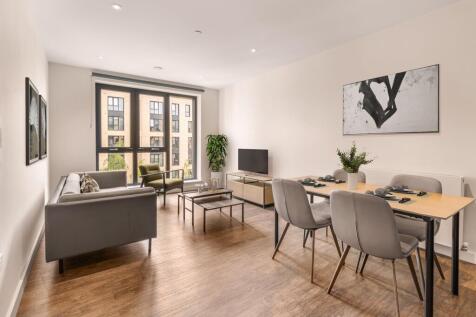 Experience elegance and comfort in a beautifully lit living and dining area.