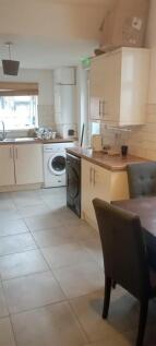 Bright kitchen with modern units and dining spa...