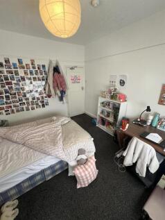Spacious bedroom with study desk and shelving...