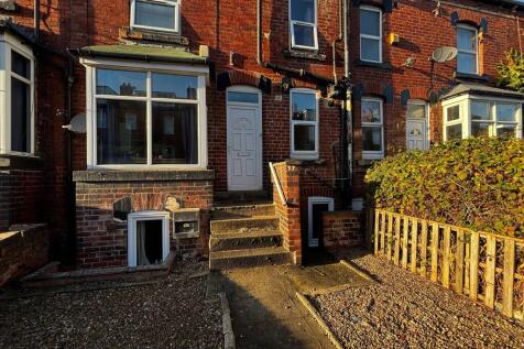 Attractive red-brick terraced house frontage wi...