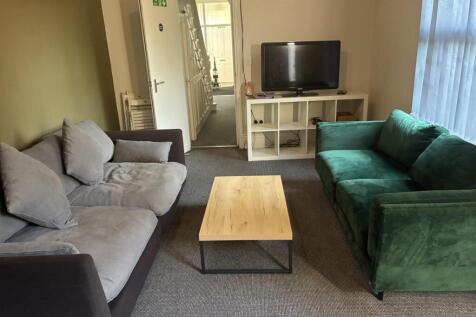 Inviting lounge with plush sofas and large TV...