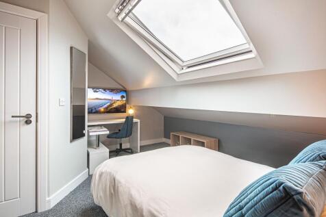 Bright and cozy bedroom with a skylight window ...