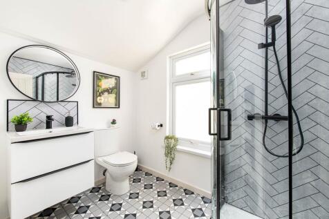 Modern bright bathroom with walk-in shower...