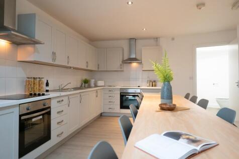 A bright and modern kitchen with ample space fo...