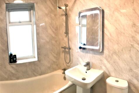 A modern bathroom featuring a sleek design with...