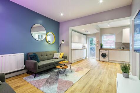 A bright and modern living room with a cozy gre...