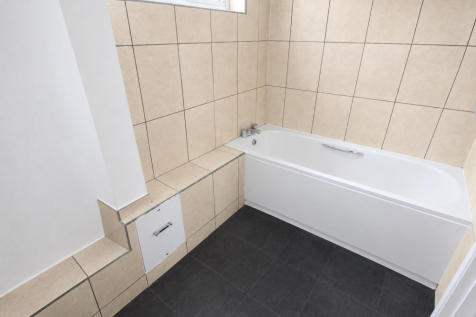 Minimalist Beige Tiled Bathroom with Bathtub.png