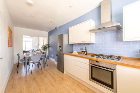 Bright modern kitchen with integrated oven and ...