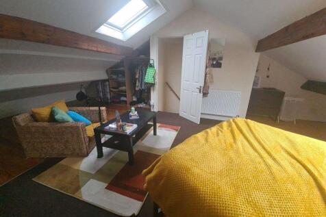 A bright and cozy living room featuring a comfo...