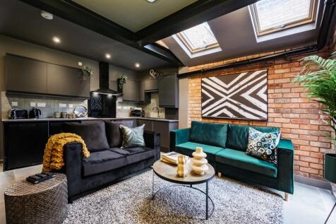 Modern, stylish living room featuring a cozy bl...