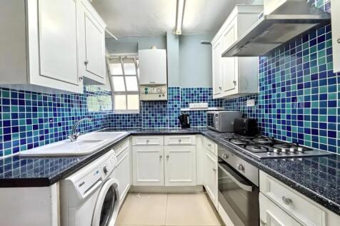 Bright kitchen with vibrant blue mosaic tiles...