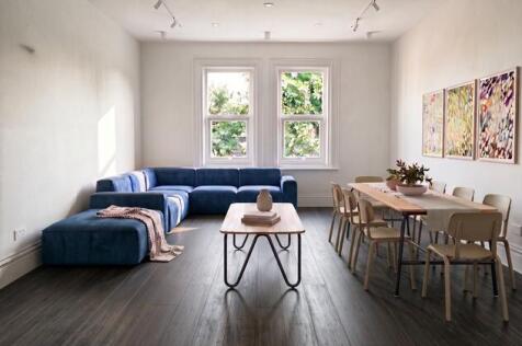 Bright lounge with a plush sofa and dining area...