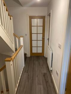Bright, modern hallway with wood-effect floorin...