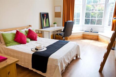 Bright bedroom with bay window and study desk...