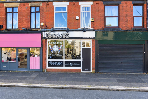 Freestylers barber shop with blank neighboring fas