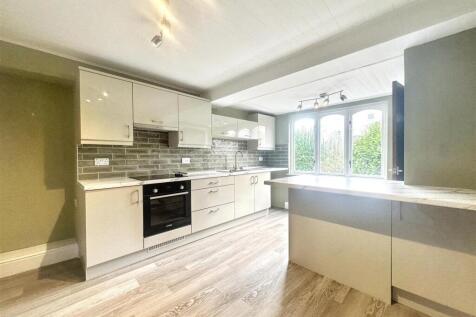 Bright modern kitchen with large breakfast bar...