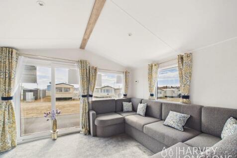Bright lounge with corner sofa and large patio doo