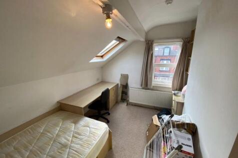 A cozy single bedroom with a comfortable bed, n...