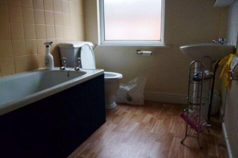 A compact bathroom featuring a bathtub, toilet,...