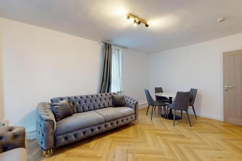 Elegant lounge with dining set and parquet floo...