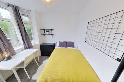 Bright bedroom with desk and modern grid decor...