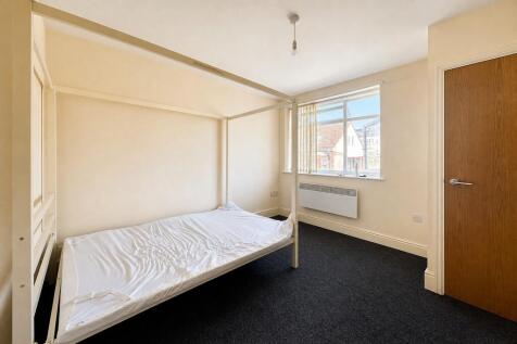 Bright double bedroom with a four-poster bed....