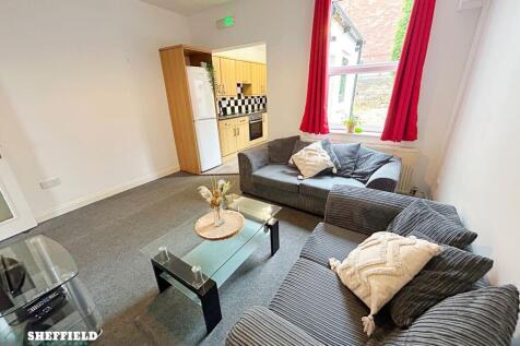 Bright furnished living room with two comfortab...