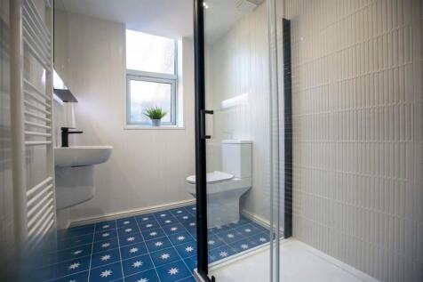 Bright modern bathroom with patterned floor...