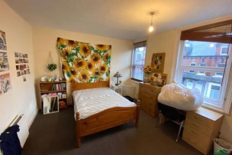 Bright, neatly arranged double bedroom with a w...