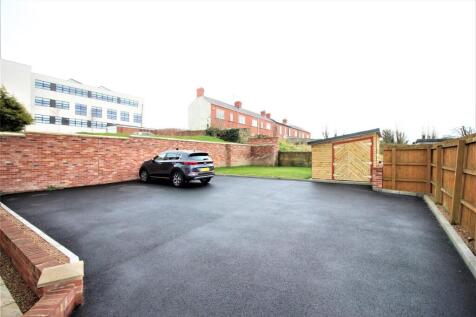 Expansive paved outdoor area with private parki...